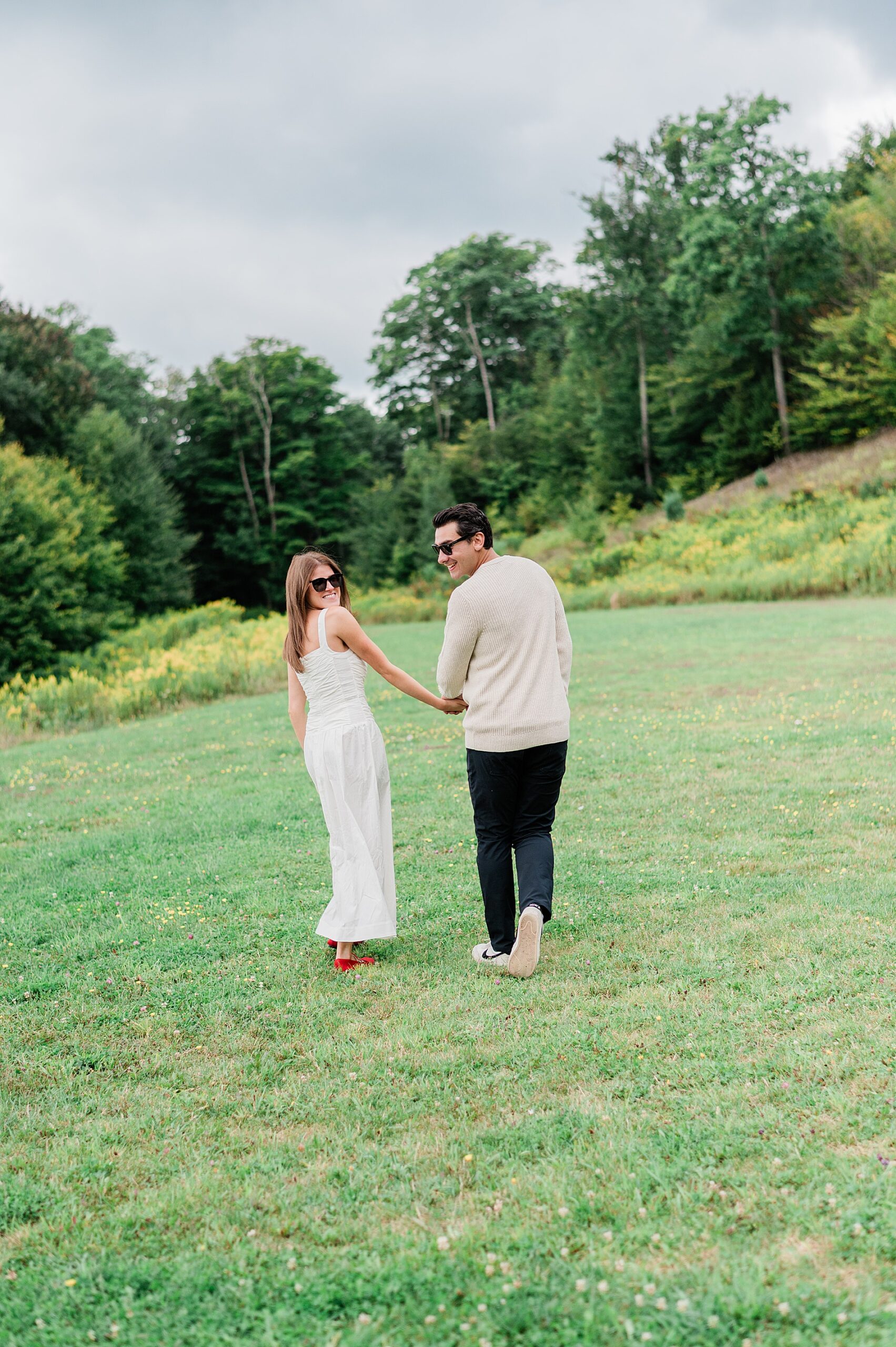 couple walk together holding hands 
