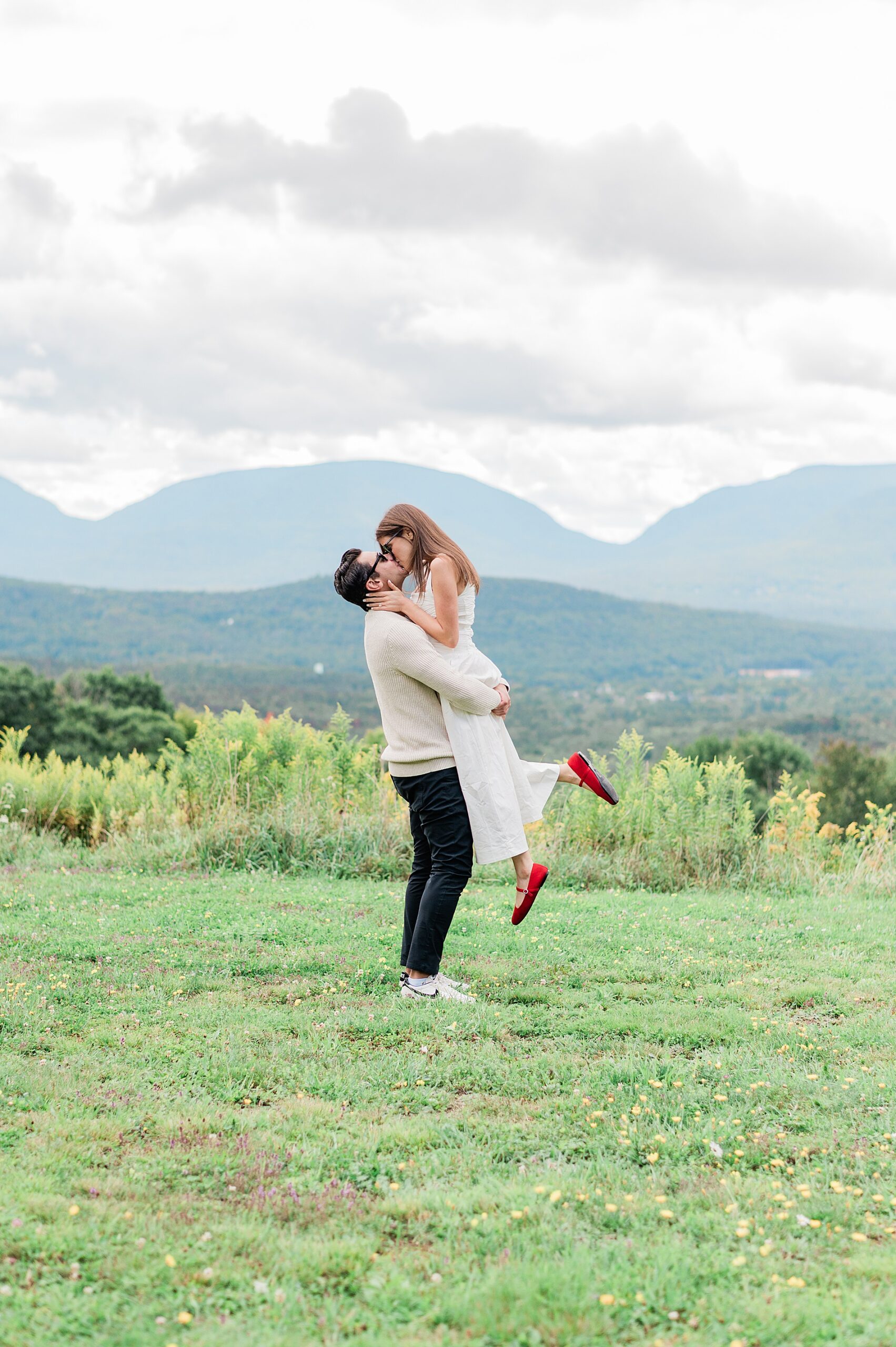 couple kiss after Surprise Proposal at Deer Mountain Inn