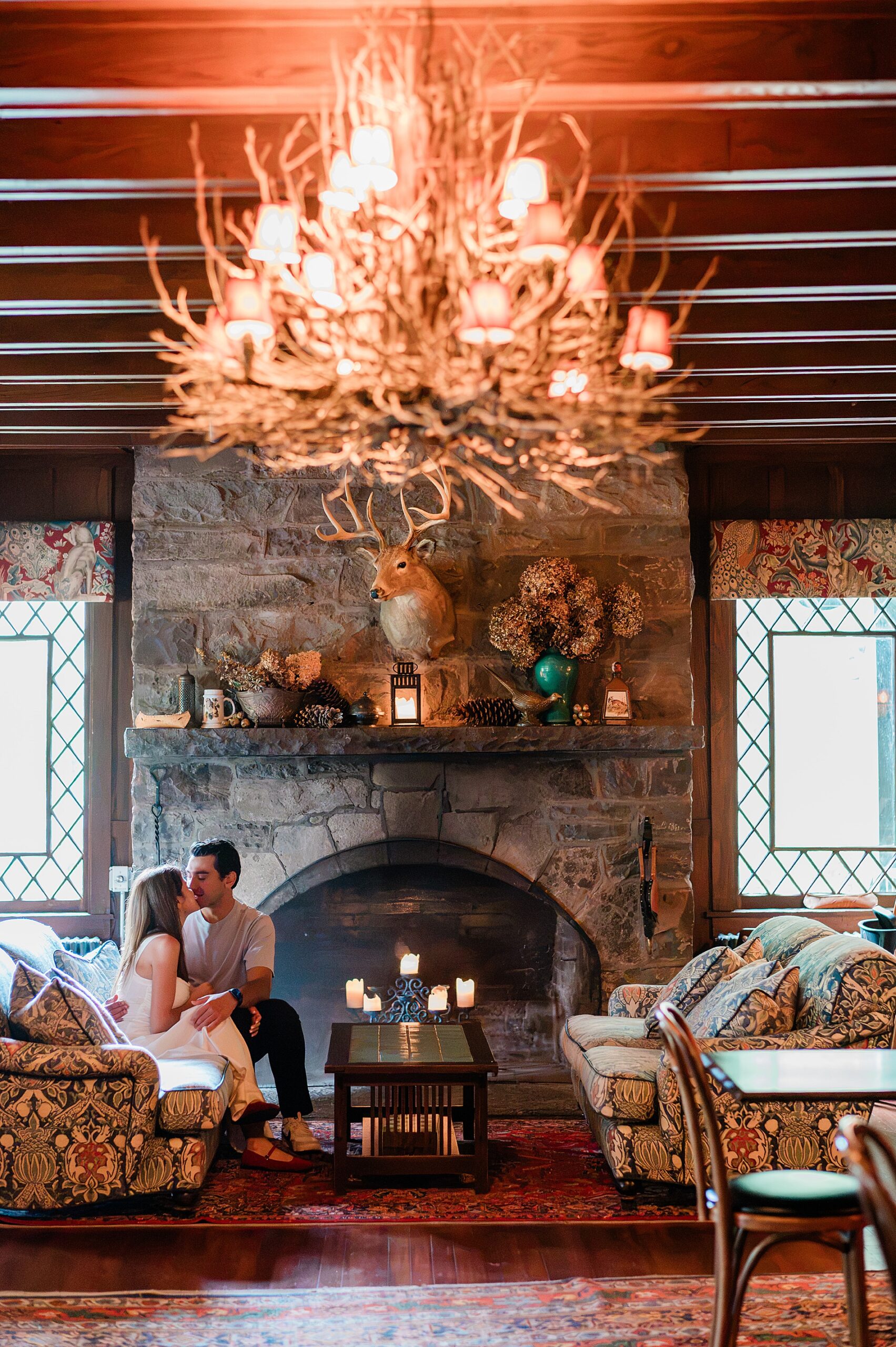 couple sitting inside lodge at Deer mountain inn 